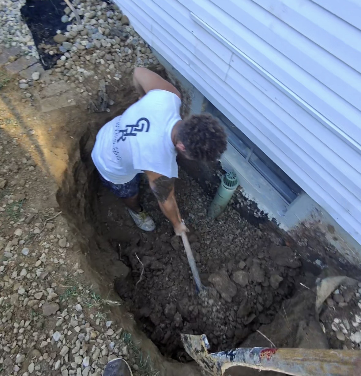 GHR Egress Windows crew hand digging a window well excavation for an egress window installation in Godfrey, IL