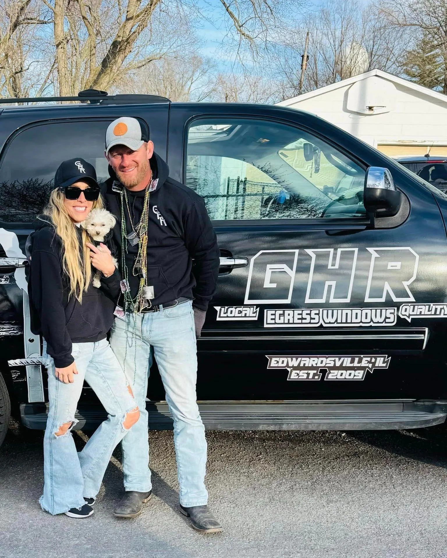 Tim and Nicci Grotefendt, owners of GHR Egress Windows, with their dog Smalls in front of company work truck in Edwardsville, IL — locally owned egress window installation specialists serving the St. Louis metro since 2009